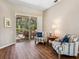 Bright living room features neutral walls, wood flooring, and a view of the screened-in patio at 355 Melrose Ct, Venice, FL 34292