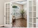 Bright home office with French doors, large window, and luxury vinyl flooring at 355 Melrose Ct, Venice, FL 34292