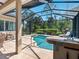 Backyard pool and lanai with outdoor kitchen and bar, ideal for entertaining and relaxation at 355 Melrose Ct, Venice, FL 34292