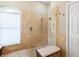 Clean shower featuring neutral-colored tiles, shower head, and shower seat at 355 Melrose Ct, Venice, FL 34292