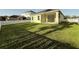 Backyard with green grass, and a screened in lanai at 3706 Shimmering Oaks Dr, Parrish, FL 34219