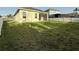 Home's backyard with green grass, and vinyl fencing at 3706 Shimmering Oaks Dr, Parrish, FL 34219