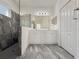 Bathroom features a dual sink vanity, walk-in shower and large mirror at 3706 Shimmering Oaks Dr, Parrish, FL 34219