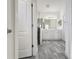 Bathroom features a dual sink vanity, walk-in shower and large mirror at 3706 Shimmering Oaks Dr, Parrish, FL 34219