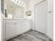 Bathroom features a dual sink vanity, walk-in shower and large mirror at 3706 Shimmering Oaks Dr, Parrish, FL 34219