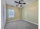 Neutral bedroom with a ceiling fan, window with blinds, and carpeted floors at 3706 Shimmering Oaks Dr, Parrish, FL 34219