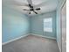 Bright blue bedroom featuring a ceiling fan, window with blinds, and carpeted floors at 3706 Shimmering Oaks Dr, Parrish, FL 34219