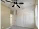 Cozy bedroom featuring a ceiling fan, carpeted floors and a closet at 3706 Shimmering Oaks Dr, Parrish, FL 34219