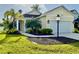 Charming one-story home featuring a well-manicured lawn and beautiful landscaping at 3706 Shimmering Oaks Dr, Parrish, FL 34219