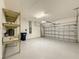 Spacious garage with ample storage space, shelving, and an automatic door at 3706 Shimmering Oaks Dr, Parrish, FL 34219