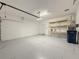 Spacious two car garage with painted floor, and storage shelves at 3706 Shimmering Oaks Dr, Parrish, FL 34219