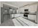 Bright kitchen features white cabinets, stainless steel appliances, tile floors and black countertops at 3706 Shimmering Oaks Dr, Parrish, FL 34219