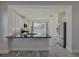 Modern kitchen with white cabinets, stainless steel appliances, and black countertops at 3706 Shimmering Oaks Dr, Parrish, FL 34219