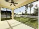 Screened lanai with ceiling fan overlooks the backyard with vinyl fence at 3706 Shimmering Oaks Dr, Parrish, FL 34219