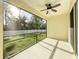 View of the screened in lanai that overlooks a grassy yard at 3706 Shimmering Oaks Dr, Parrish, FL 34219