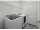 Laundry room features modern appliances, shelving, and door to utility area at 3706 Shimmering Oaks Dr, Parrish, FL 34219