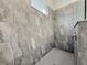 Bathroom walk-in shower features gray tiling and a shower head at 3706 Shimmering Oaks Dr, Parrish, FL 34219