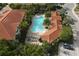 Aerial shot showcasing the community pool surrounded by lush landscaping and red-tiled roofs at 4236 Expedition Way # 106, Osprey, FL 34229
