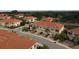 Aerial view of a well-kept neighborhood with townhomes, each with a one-car garage, and tropical landscaping at 4236 Expedition Way # 106, Osprey, FL 34229