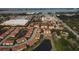 Aerial view of the community and its ponds with a shopping center and Tampa Bay in the distance at 4236 Expedition Way # 106, Osprey, FL 34229
