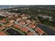 Aerial view of the community showcasing its tranquil setting near ponds and lush greenery, with easy access to Tampa Bay at 4236 Expedition Way # 106, Osprey, FL 34229