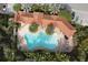 An aerial shot of a uniquely-shaped pool with palm trees, lounge chairs and lush landscaping surrounding the community at 4236 Expedition Way # 106, Osprey, FL 34229