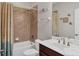 Bathroom featuring a shower-tub combo, a vanity with a dark wood base, and sea-themed decor at 4236 Expedition Way # 106, Osprey, FL 34229