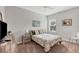 Well-lit bedroom with a ceiling fan, a large window, and earth-tone furnishings and decorations at 4236 Expedition Way # 106, Osprey, FL 34229