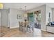 Dining room features a glass-top table, patio access, and neutral colors at 4236 Expedition Way # 106, Osprey, FL 34229