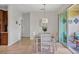 Cozy dining room with light wood furniture and outdoor access at 4236 Expedition Way # 106, Osprey, FL 34229