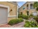 Charming walkway leading to a home featuring stucco siding and well-maintained landscaping at 4236 Expedition Way # 106, Osprey, FL 34229