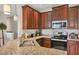 Well-equipped kitchen boasts dark cabinets, granite counters, and modern stainless appliances at 4236 Expedition Way # 106, Osprey, FL 34229