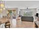 Open-concept living area featuring neutral tones, tile floors, dining area, and sliding glass doors to the outside at 4236 Expedition Way # 106, Osprey, FL 34229