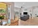 Bright living room with sliding doors to balcony and view of dining space and hall at 4236 Expedition Way # 106, Osprey, FL 34229