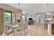 Open-concept living area with dining, living, and patio access. Abundant natural light at 4236 Expedition Way # 106, Osprey, FL 34229