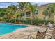A serene pool area with lounge chairs and a view of the well-maintained community at 4236 Expedition Way # 106, Osprey, FL 34229