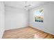 Inviting bedroom featuring hardwood floors, a ceiling fan, and a window offering ample natural light at 4713 Sweetmeadow Cir, Sarasota, FL 34238