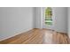 This well-lit bedroom features beautiful wood floors and a large window at 4713 Sweetmeadow Cir, Sarasota, FL 34238