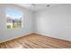 A naturally-lit bedroom with wood flooring and neutral walls at 4713 Sweetmeadow Cir, Sarasota, FL 34238