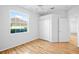 Bright bedroom features wood floors, a large window, and a closet at 4713 Sweetmeadow Cir, Sarasota, FL 34238