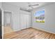 Comfortable bedroom with hardwood floors, a large window, and spacious closets at 4713 Sweetmeadow Cir, Sarasota, FL 34238