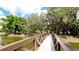 View of the community bridge surrounded by lush trees at 4713 Sweetmeadow Cir, Sarasota, FL 34238