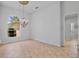 Open room with neutral tile floors, a chandelier, and bright, airy spaces at 4713 Sweetmeadow Cir, Sarasota, FL 34238