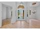 Bright foyer featuring tile flooring, high ceilings, and stylish lighting fixtures at 4713 Sweetmeadow Cir, Sarasota, FL 34238