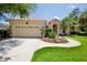Charming home featuring a clay tile roof, attached two-car garage, and a well-manicured front lawn at 4713 Sweetmeadow Cir, Sarasota, FL 34238