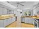 Modern kitchen featuring white cabinetry, granite countertops, stainless steel appliances, and tile flooring at 4713 Sweetmeadow Cir, Sarasota, FL 34238