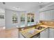 Bright kitchen featuring granite countertops, stainless steel appliances, and a view of the pool at 4713 Sweetmeadow Cir, Sarasota, FL 34238