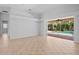 Bright living room with tile flooring and sliding glass doors offering views of the pool at 4713 Sweetmeadow Cir, Sarasota, FL 34238