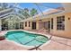 Sparkling pool with waterfall feature surrounded by a screened enclosure and lush landscaping at 4713 Sweetmeadow Cir, Sarasota, FL 34238