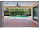 Enclosed pool area with view of outdoor living space and surrounding landscaping at 4713 Sweetmeadow Cir, Sarasota, FL 34238